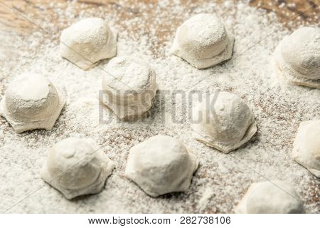 Uzbek National Food Chuchvara, Like Dumplings, On A Wooden Board, In Flour