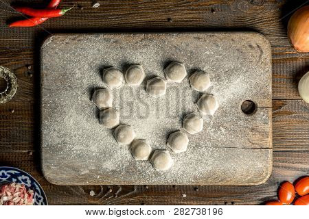 Uzbek National Food Chuchvara, Like Dumplings, Lie In The Shape Of A Heart, On A Wooden Board, In Fl