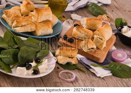 Spinach Puffs With Feta Cheese On Cutting Board.