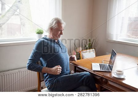 Senior Working On Computer Having Low Back Pain