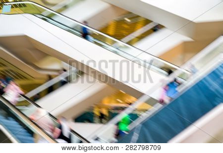 People On Escalotors In Shoppimg Centre. Blurred Motion