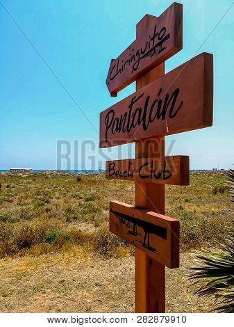 Wooden Sign With Arrows Indicating The Way To The Beach Of Puerto De Sagunto