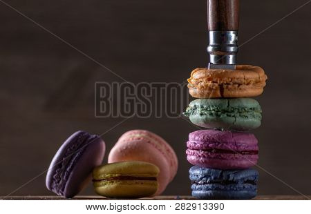 A Famous Model Of A French Knife Sticks Out Of Cookies On A Dark Wooden Background. Multi-colored Ma