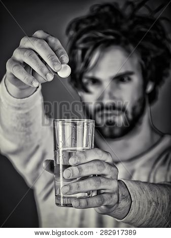 Guy After Sleepless Night Takes Pill From Headache. Aspirin, Drugs And Health Care. Man Holding Glas