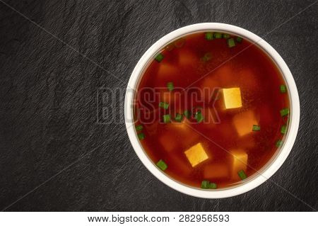 Miso Shiru Soup With Tofu And Scallions, Shot From The Top On A Black Background With A Place For Te