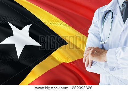 Timorese Doctor Standing With Stethoscope On East Timor Flag Background. National Healthcare System 