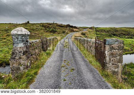 A Stone Bridge Goining Over A Stream In Rural County Galway Ireland
