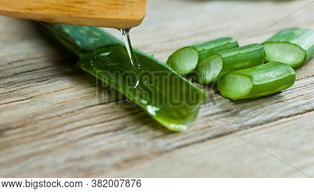 Aloe Vera Gel Close Up. Sliced Aloevera Leaf And Gel With Wooden Spoon , Natural Organic Cosmetic In