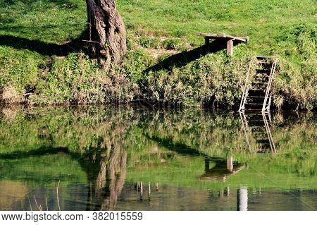 Improvised Homemade River Diving Board Made From Wooden Planks Mounted On Supporting Poles Next To W