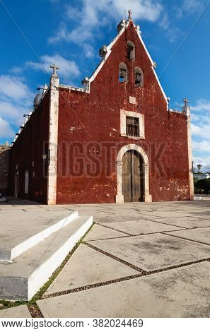 Catholic Red Colonial Church Itzimna In A Sunny Park, Merida, Yucatan, Mexico