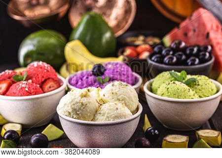 Vegan Ice Cream Made With Organic Fruits, With Tropical Fruits In The Background, Flavors Of Strawbe