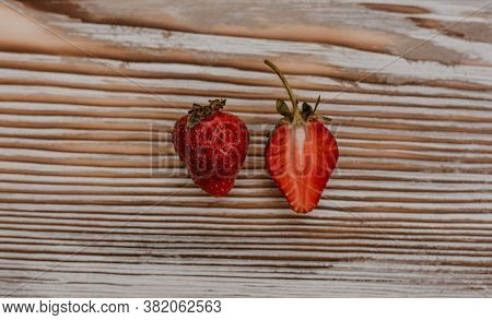 Juicy Red Strawberry Lies On The Wooden Board