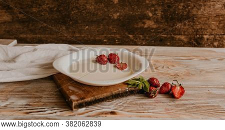 Juicy Red Strawberry Lies On The Wooden Board