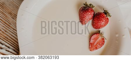 Juicy Red Strawberry Lies On The Wooden Board