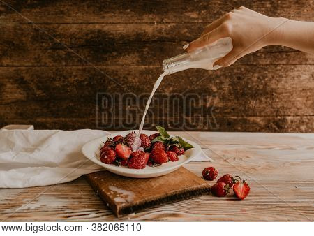 Juicy Red Strawberry Lies On The Wooden Board