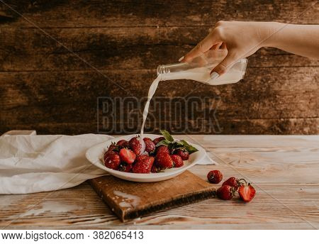 Juicy Red Strawberry Lies On The Wooden Board