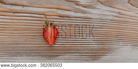 Juicy Red Strawberry Lies On The Wooden Board