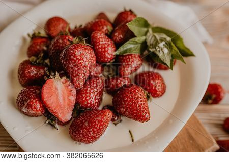 Juicy Red Strawberry Lies On The Wooden Board
