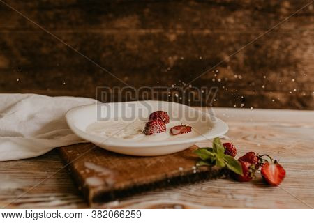 Juicy Red Strawberry Lies On The Wooden Board