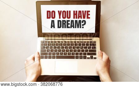 Young Man Checking His Laptop, Top View. Text Do You Have A Dream