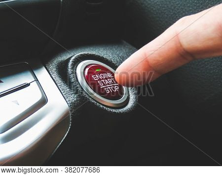 Car Driver Press To The Engine Start Stop Button For Engine Ignition In A Luxury Car