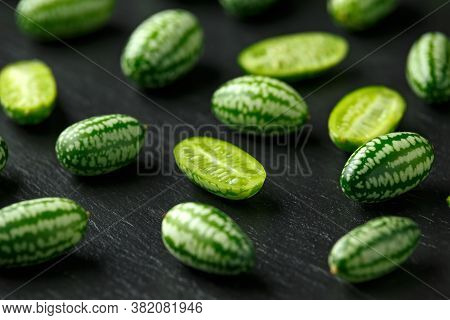 Fresh Green Cucamelon On Rustic Stone Board