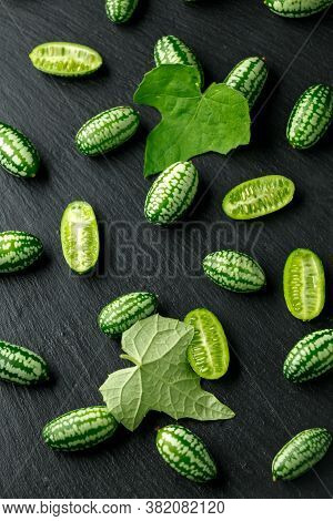 Fresh Green Cucamelon On Rustic Stone Board