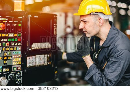 Factory Worker Man Operate The Machine, High Skill Labor Work Industry With Safety Clothes.