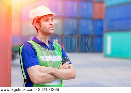 Portrait Of Shipping Worker Man Proud Of Work In Cargo Port For Import Export Goods Standing Smile.