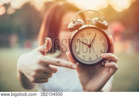 Closeup Hand Pointing At Clock Times For It's Time To Do Urgent Or Notice Concept.