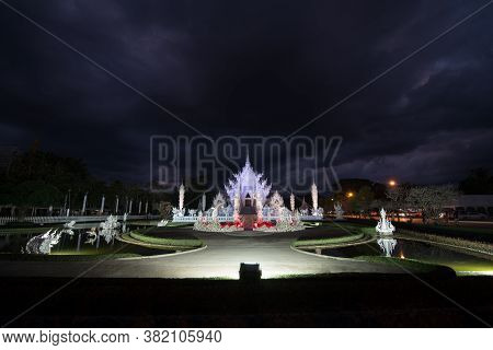 Scenery Of Wat Rong Khun Or White Temple Light Up On Light Fest Event With Dramatic Sky In Chiangrai