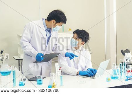 Two Asian Scientist Team Reserch Chemistry Science Tube Experiment Biotech Antibody Sample In Labora