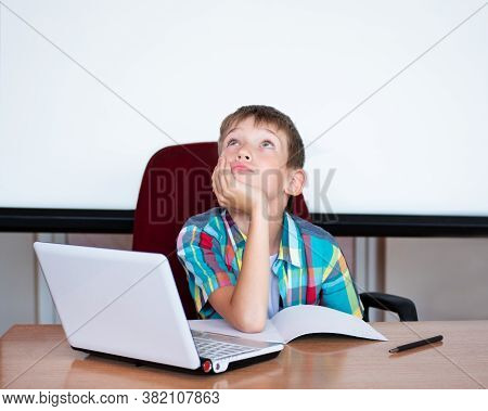 A Cute Boy Sits At The Table, Looks Up, Remembers His Homework. The Boy Didnt Learn His Homework, Co