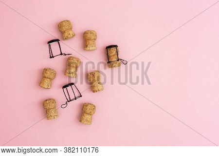 Wooden Corks And Muselets From Bottle Of Champagne On Pink Colored Background With Empty Space For Y