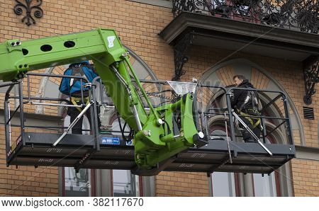 Sundsvall, Norrland Sweden - July 15, 2020: Two Men Working On Cleaning Windows From A Crane Truck