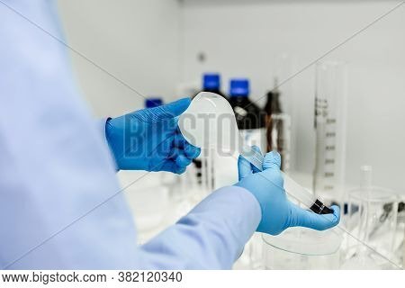 Flask In Scientist Hand With Dropping Chemical Liquid To Test Tubes, Science And Medical Research An