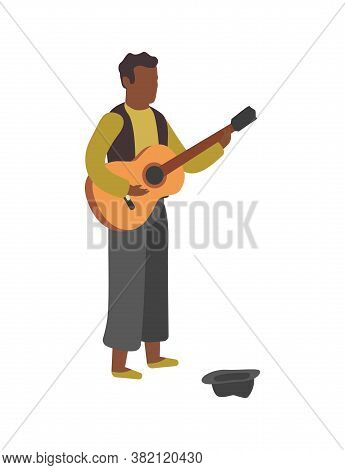 Man Plays Guitar On Street. Busker Performance, Boy Stands With Hat And Play Melody, Earn Money With