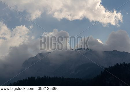 Misty Fog After Rain On Austia Alps Mountain With Blue Sky