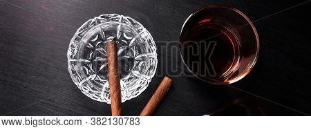 Banner Of Glass Of Whiskey With Smoking Cigar On Dark Wooden Table.