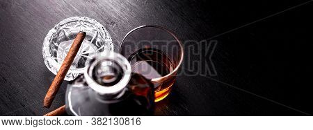 Banner Of Glass Of Whiskey With Smoking Cigar On Dark Wooden Table.