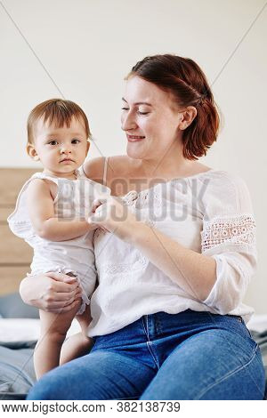 Portrait Of Happy Smiling Woman In White Crochet Blouse Enjoying Speding Time With Her Little Daught