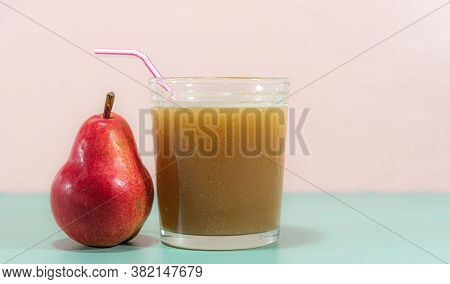 Pear Juice And Fruit On Green Surface On Pink Background