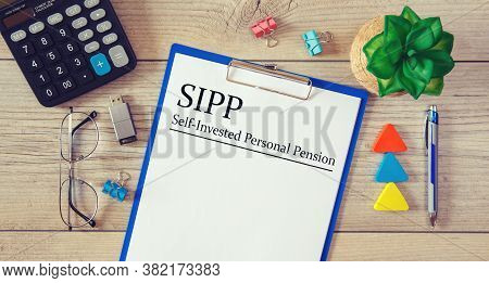 Paper With Individual Personal Pension Sipp On The Table, Calculator And Glasses