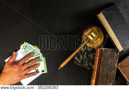 Money And Judges Hammer On Wooden Table. Representation Of Corruption And Bribery In The Judiciary. 