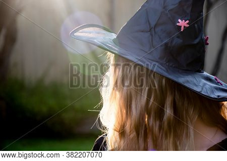 Causcasian Blond Girl With Long Hair In Halloween Witch Hat