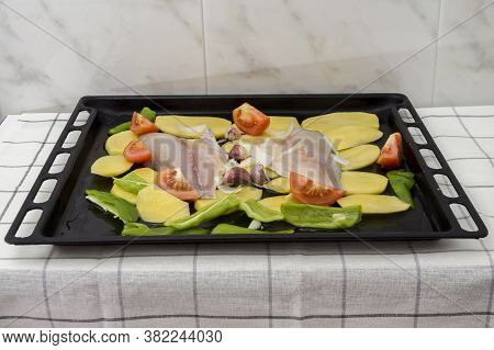 Uncooked Baked Sea Bream Fish Fillets With Tomatoes And Green Peppers.