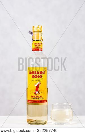 Prague, Czech Republic - October 19, 2019. Bottle Of Gusano Rojo Mezcal With Shot On Light Backgroun