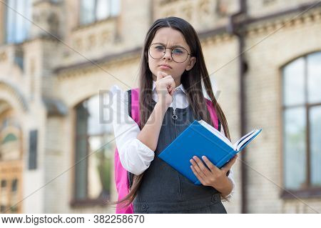 Imagine Your Dreams. Little Kid Hold Book With Thoughtful Look. Imaginative Thinking. School Time. C