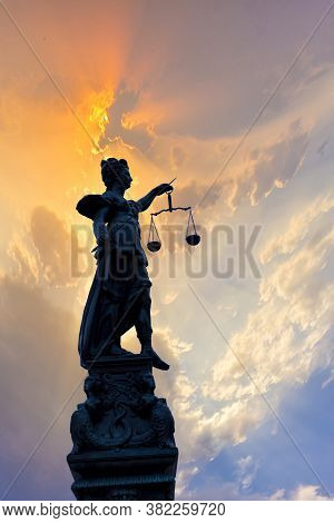 Silhouette Of Lady Justice At The Fountain At Romerberg In Frankfurt, Germany