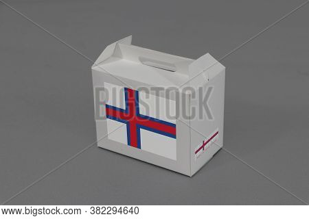 Faroe Flag On White Box With Barcode And The Color Of Nation Flag On Grey Background. The Concept Of